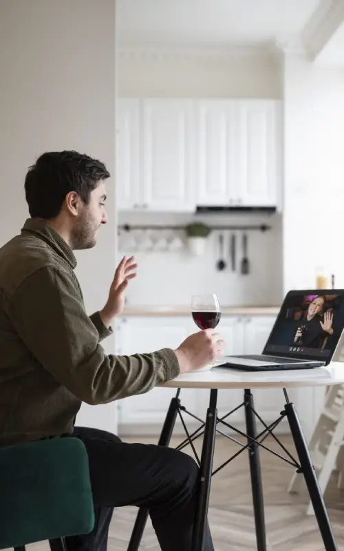 A man hand on wine Glass and watch laptop